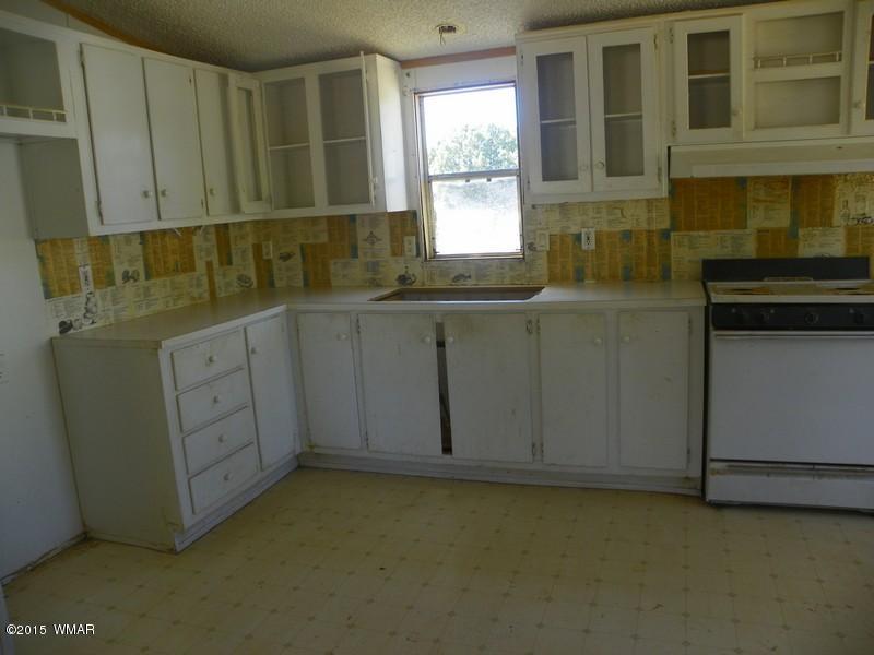 4452 East Pinto Road Snowflake, AZ 85937 - Photo 4 of 21 a kitchen with stainless steel appliances granite countertop a stove a sink and a microwave