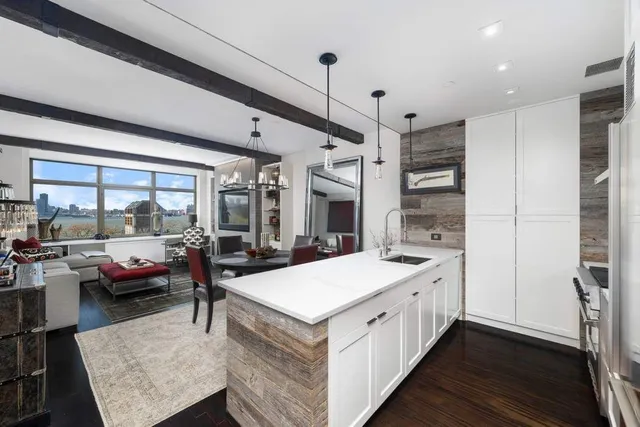 a large white kitchen with a large window
