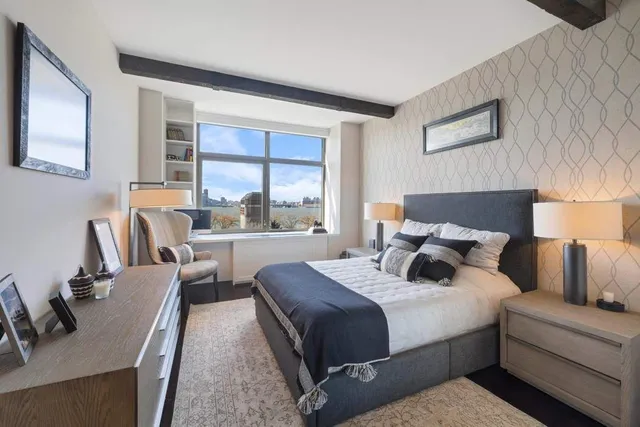 a bedroom with a large bed and a couch