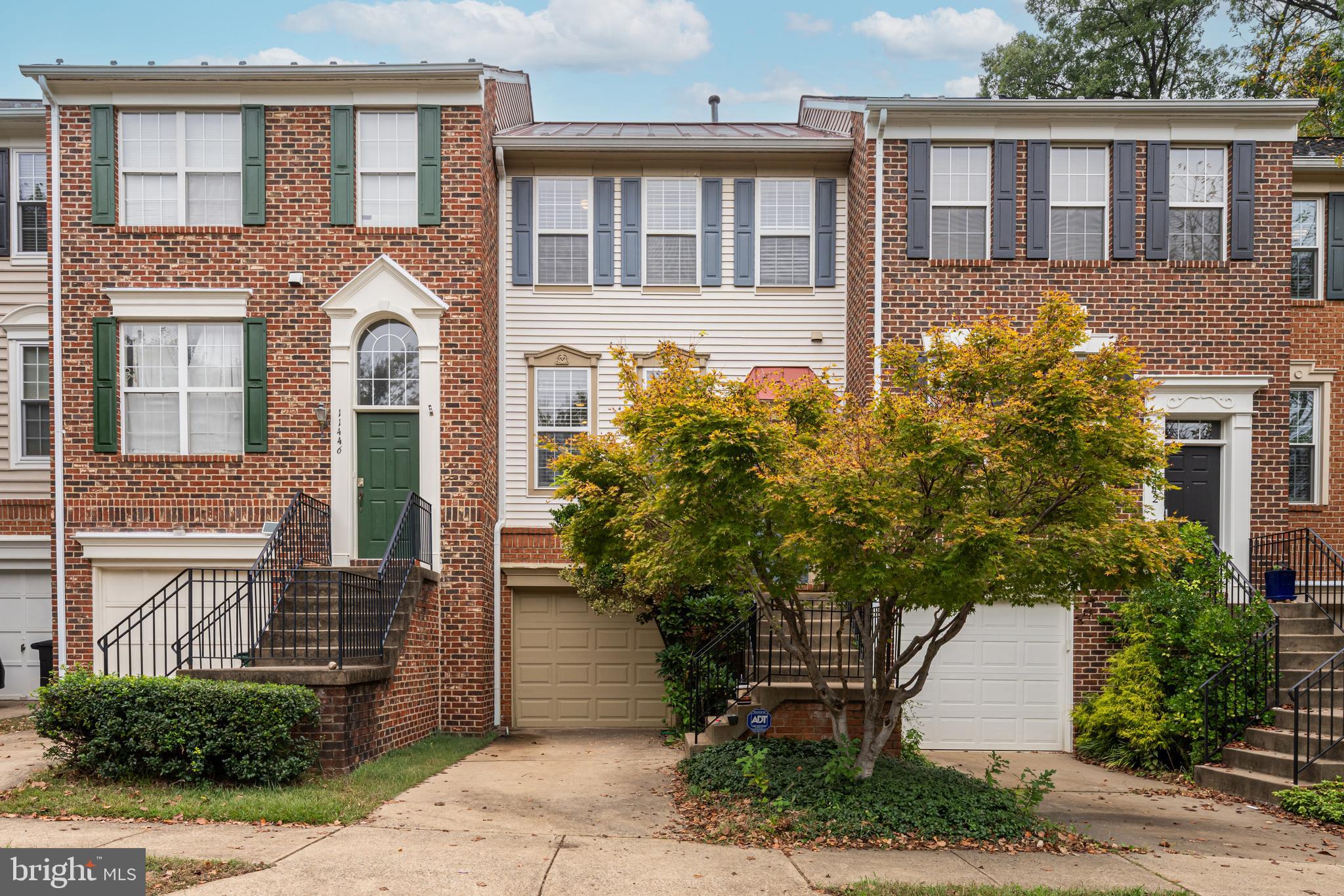 11444 Heritage Commons Way Reston, VA 20194 - Photo 1 of 35 a front view of a house with a garden