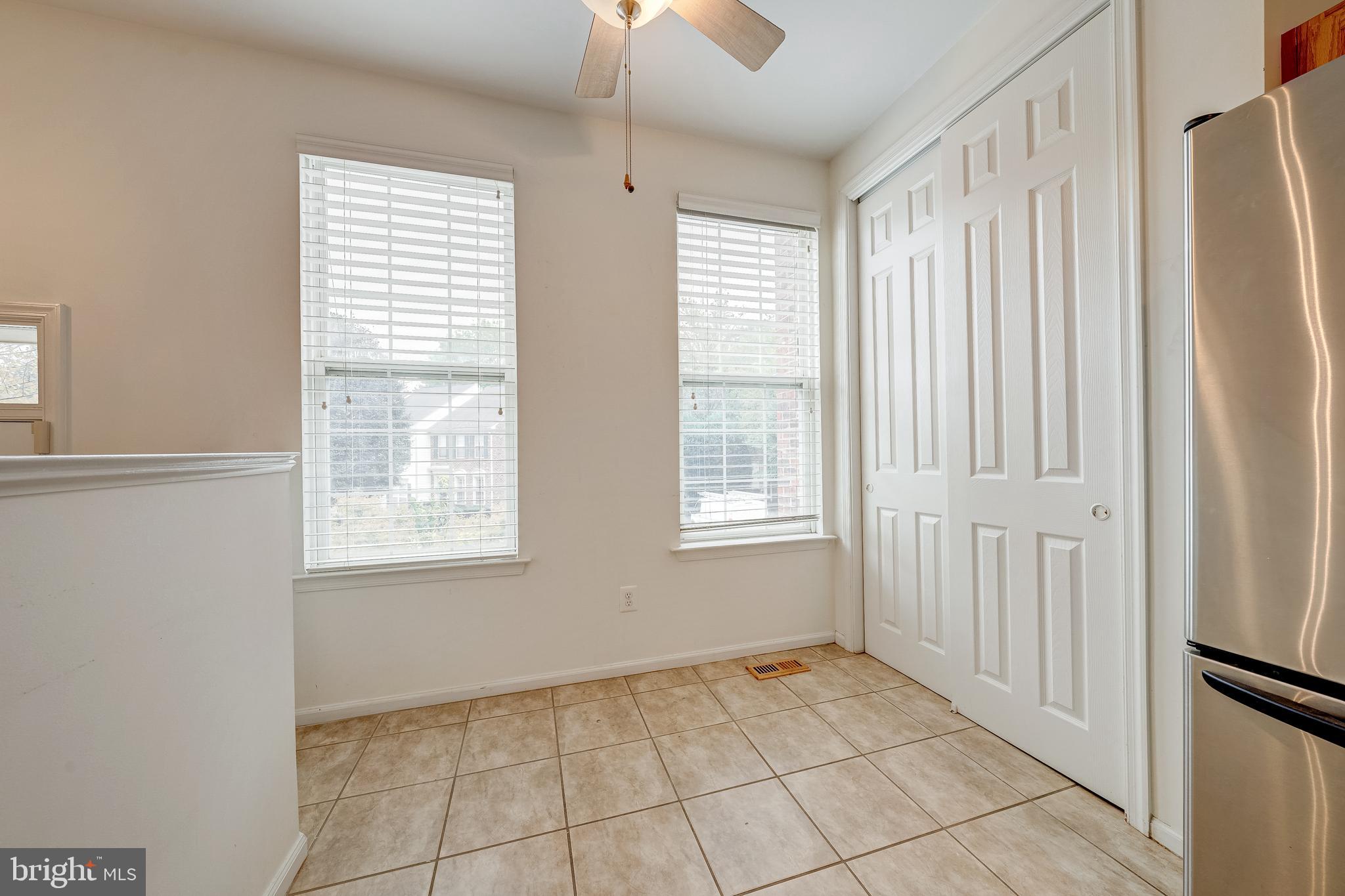 11444 Heritage Commons Way Reston, VA 20194 - Photo 13 of 35 an empty room with windows and fan