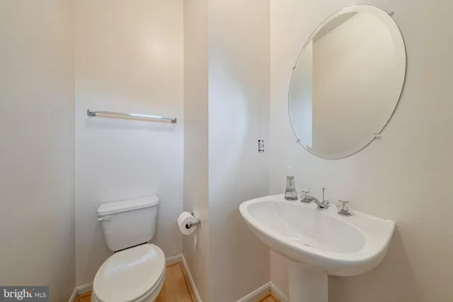 a bathroom with a sink a mirror and a toilet