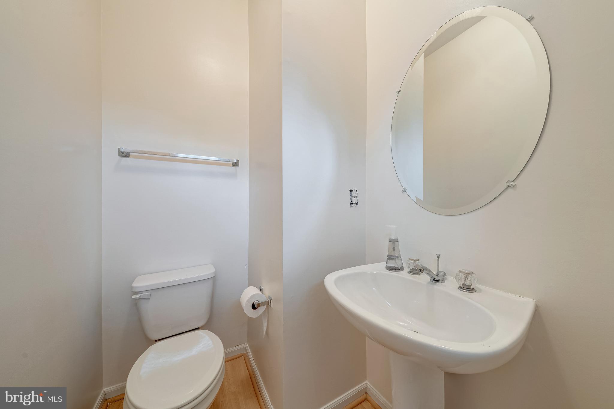 11444 Heritage Commons Way Reston, VA 20194 - Photo 14 of 35 a bathroom with a sink a mirror and a toilet