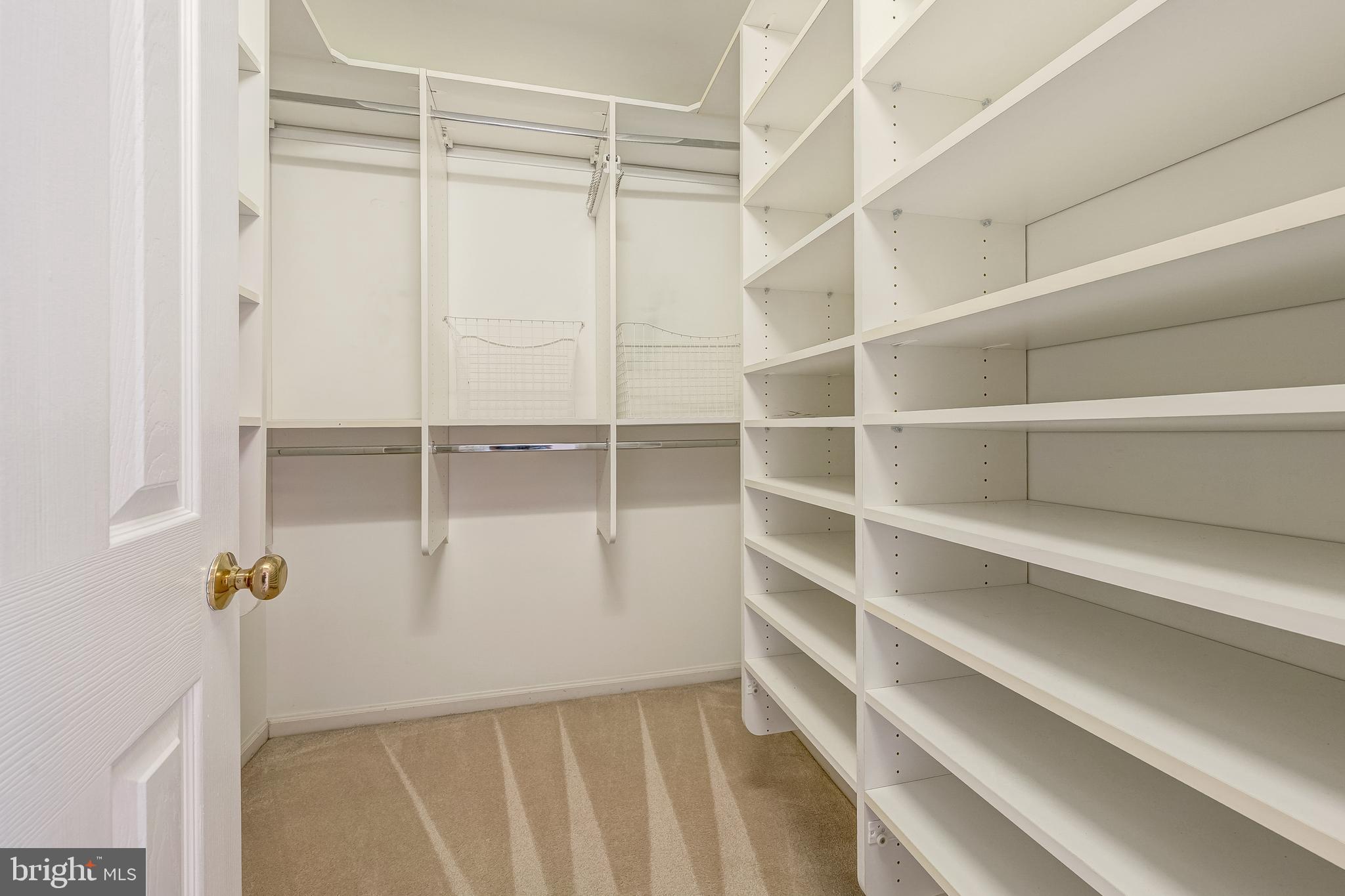 11444 Heritage Commons Way Reston, VA 20194 - Photo 20 of 35 a view of walk in closet with empty racks