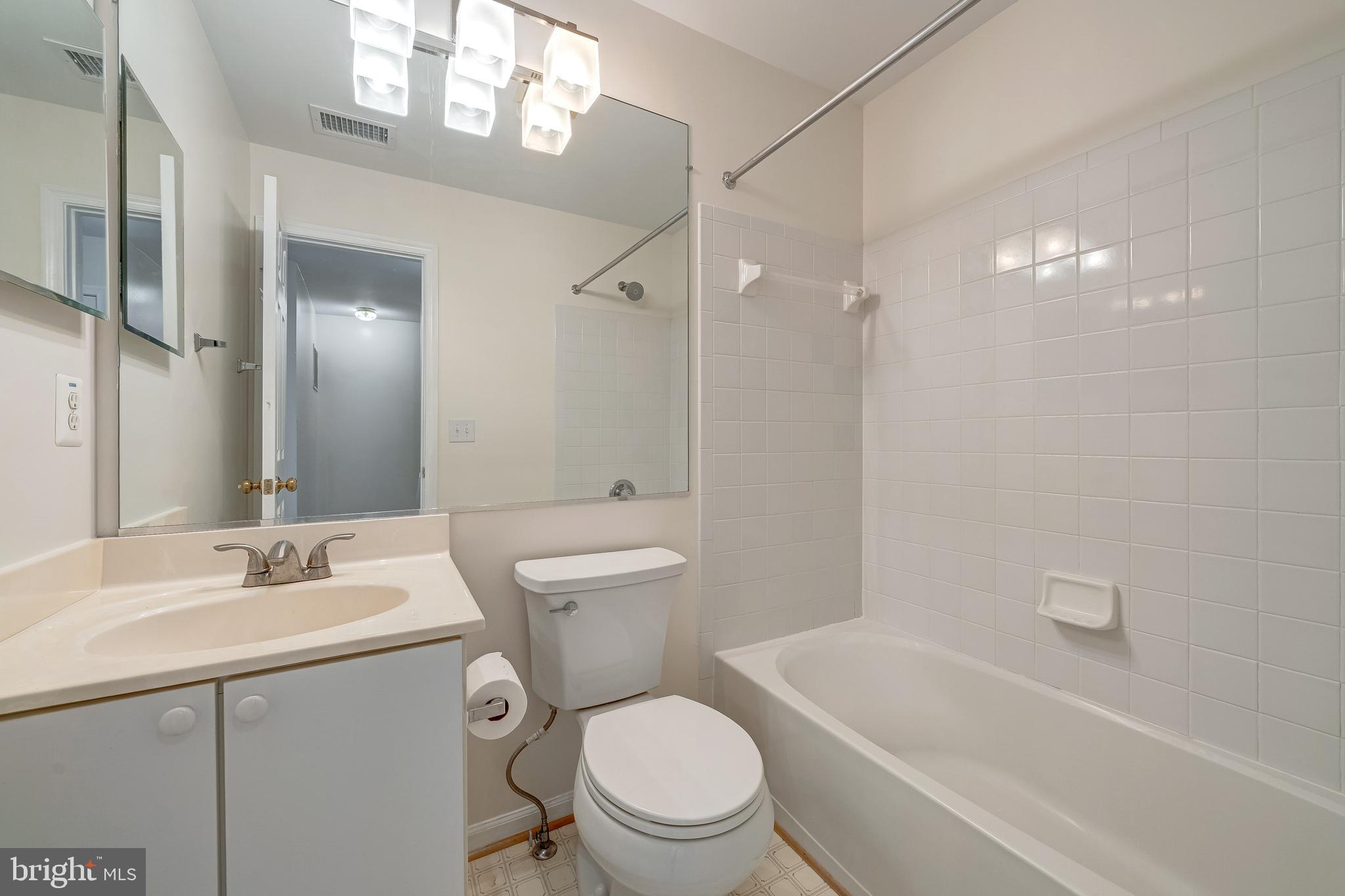 11444 Heritage Commons Way Reston, VA 20194 - Photo 25 of 35 a bathroom with a sink a toilet a mirror and shower