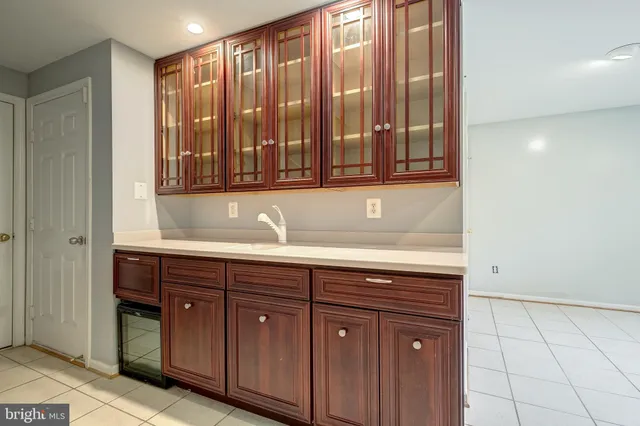 a sink with a granite countertop cabinets