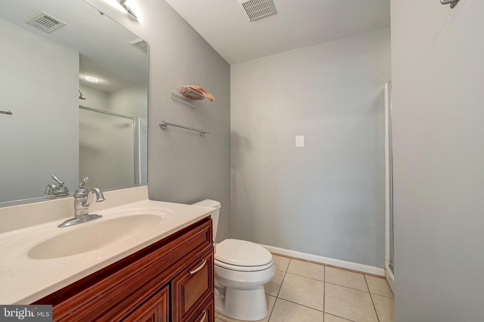 11444 Heritage Commons Way Reston, VA 20194 - Photo 31 of 35 a bathroom with a sink a toilet and shower
