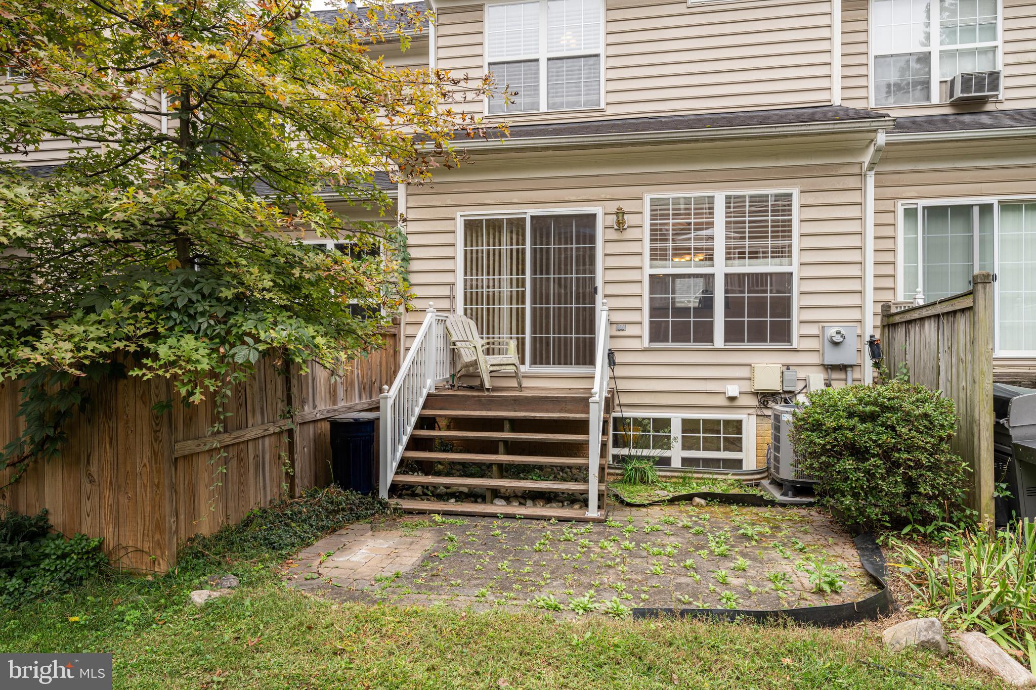 11444 Heritage Commons Way Reston, VA 20194 - Photo 33 of 35 a view of a house with a small yard and wooden fence and large tree