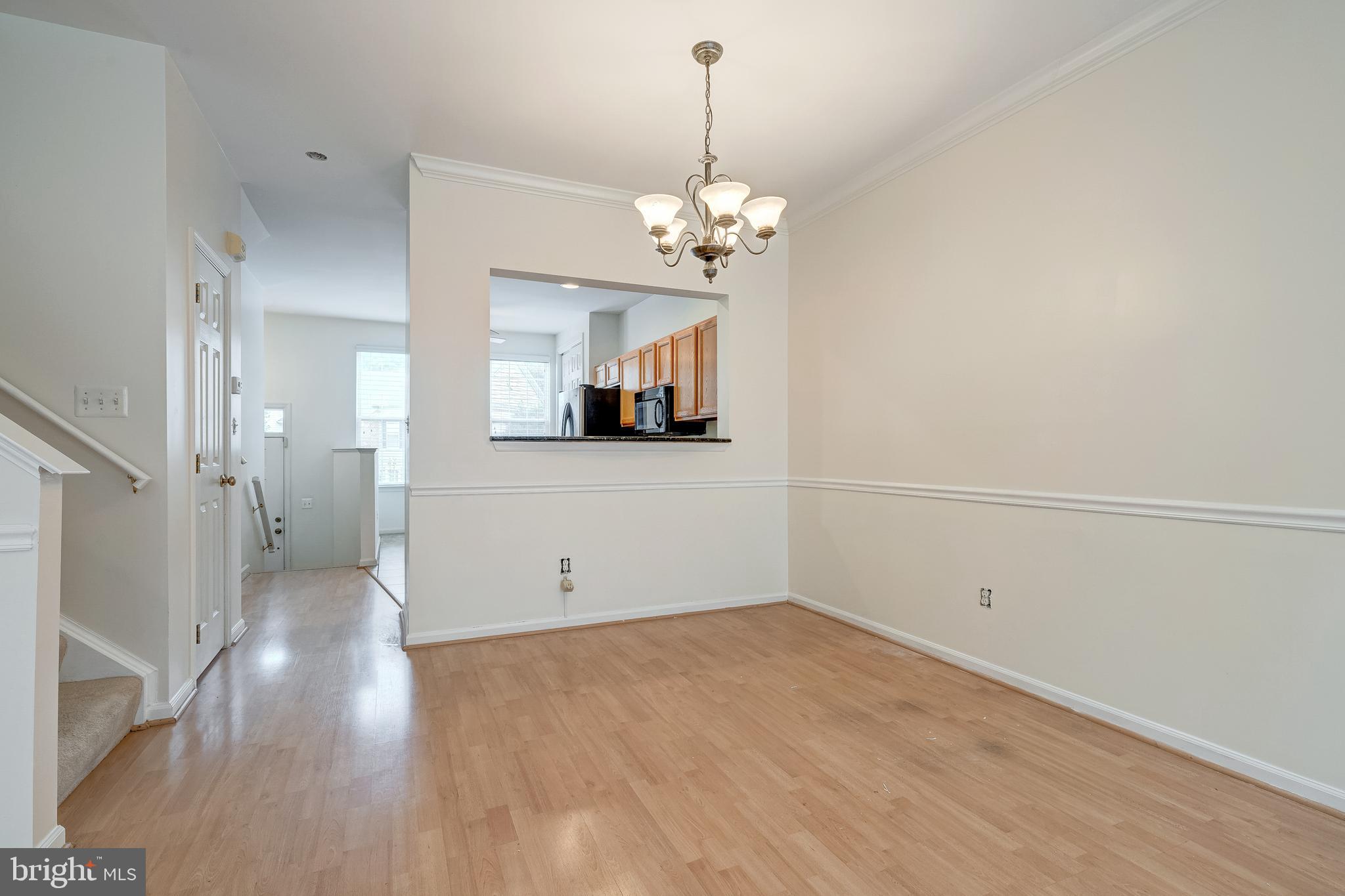 11444 Heritage Commons Way Reston, VA 20194 - Photo 8 of 35 a view of a room with wooden floor and a chandelier