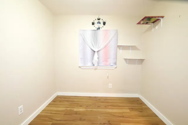 a view of a room with wooden floor and cabinet
