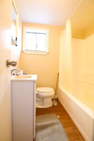 a bathroom with a toilet a sink and mirror