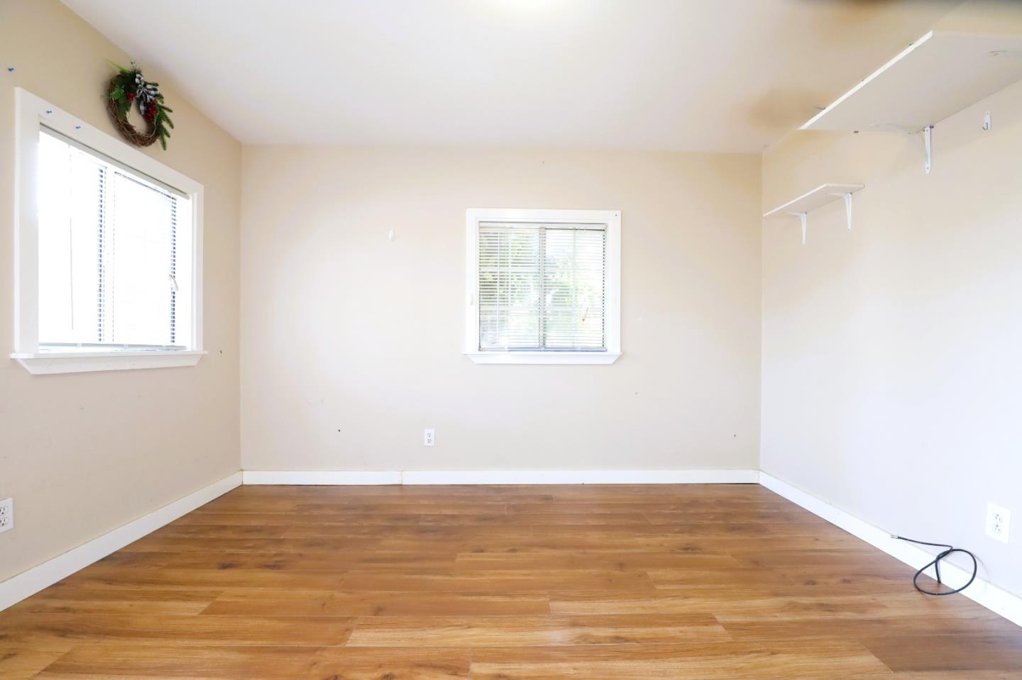2855 Senter Road, Unit 10 San Jose, CA 95111 - Photo 2 of 15 an empty room with wooden floor and windows