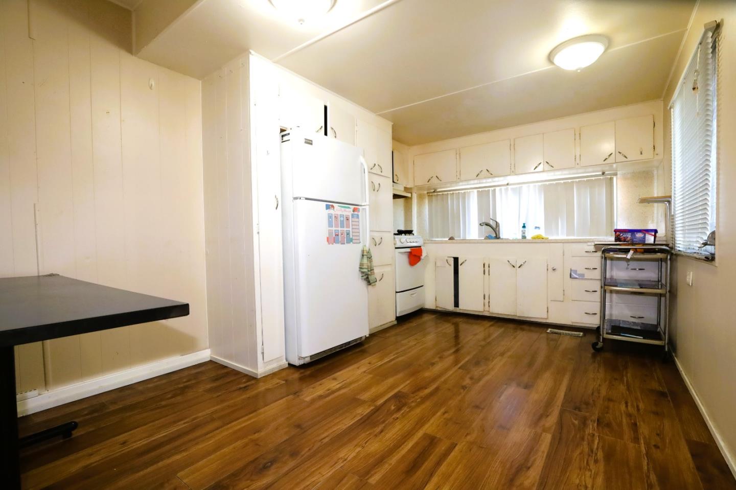 2855 Senter Road, Unit 10 San Jose, CA 95111 - Photo 3 of 15 a kitchen with cabinets and wooden floor