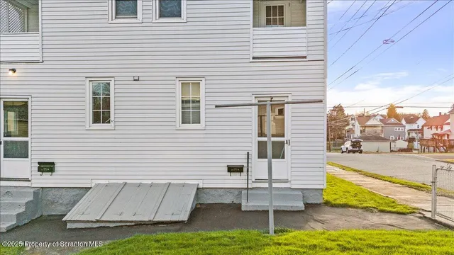 a view of a white house with a swimming pool