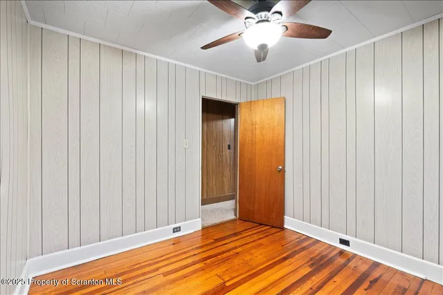 a view of a room with a ceiling fan