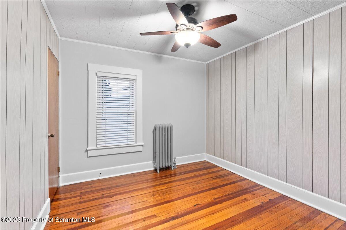 1446 Thackery Street Scranton, PA 18504 - Photo 14 of 25 a view of empty room with wooden floor and fan
