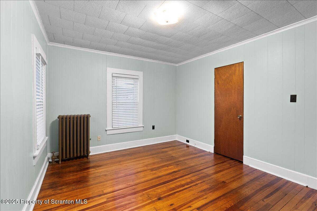 1446 Thackery Street Scranton, PA 18504 - Photo 16 of 25 an empty room with wooden floor and windows