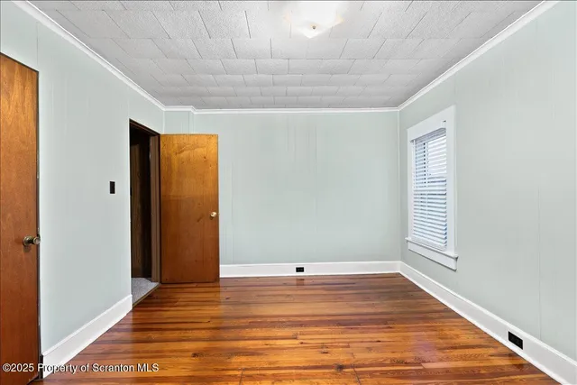 a view of room with window and wooden floor