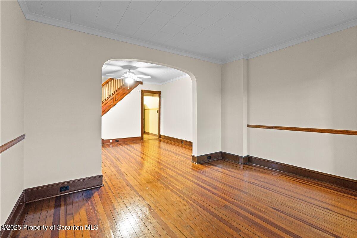 1446 Thackery Street Scranton, PA 18504 - Photo 18 of 25 a view of empty room with wooden floor and fan