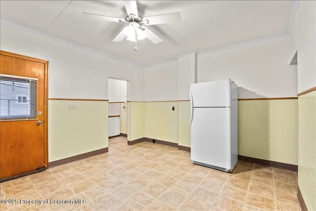 a view of a kitchen with a refrigerator and a stove top oven