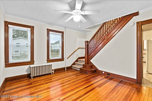 wooden floor in a hall with a window and wooden floor