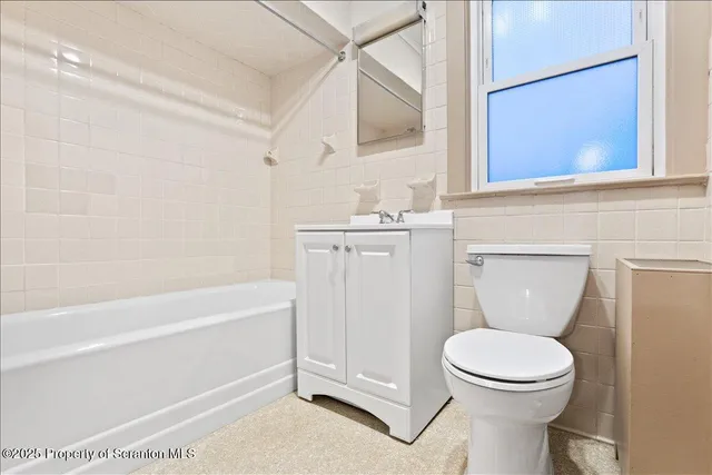 a bathroom with a toilet a sink and bathtub