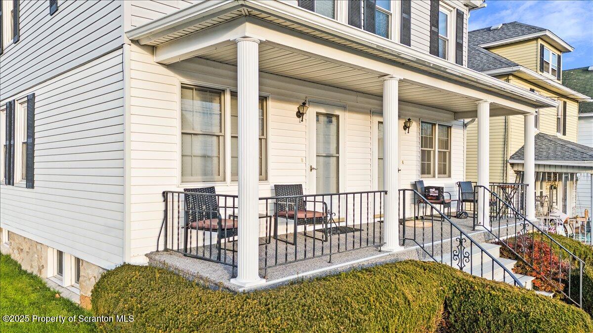 1446 Thackery Street Scranton, PA 18504 - Photo 9 of 25 a view of a house with large windows and furniture