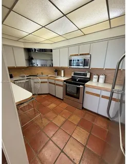 a kitchen with stainless steel appliances granite countertop a sink and cabinets
