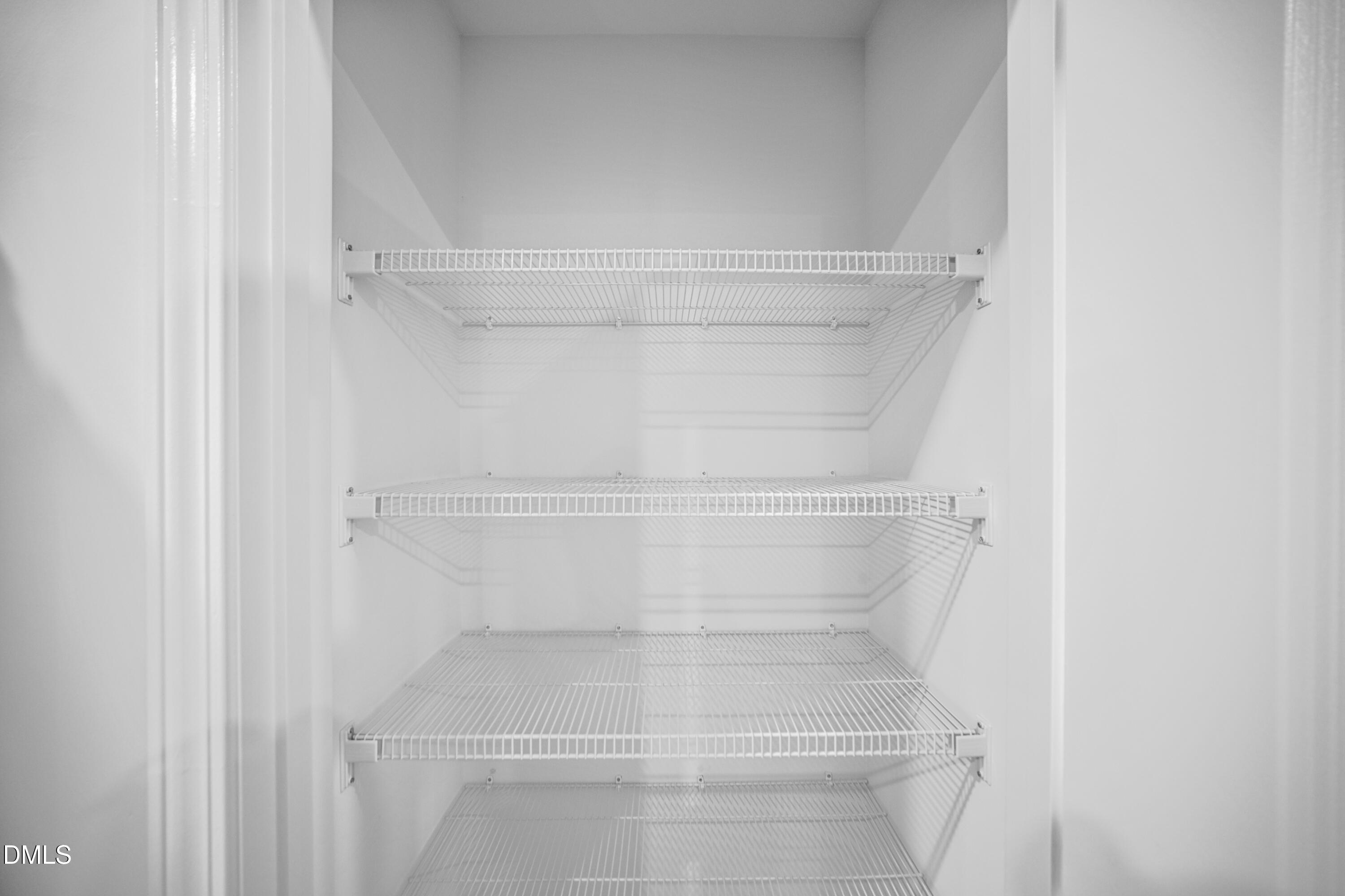 1445 Jay Road Knightdale, NC 27545 - Photo 17 of 58 a view of walk in closet with empty racks