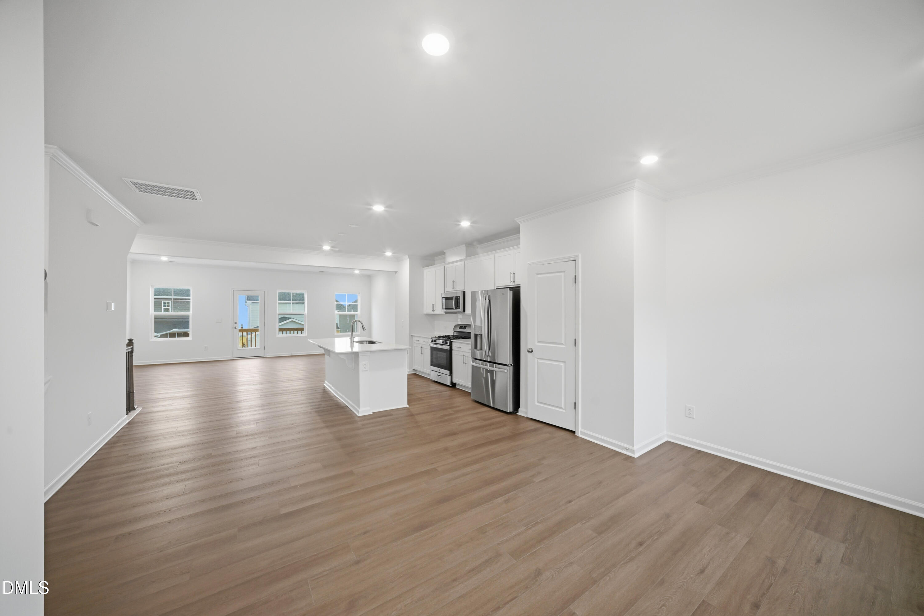 1445 Jay Road Knightdale, NC 27545 - Photo 8 of 58 a view of a kitchen with a refrigerator and wooden floor