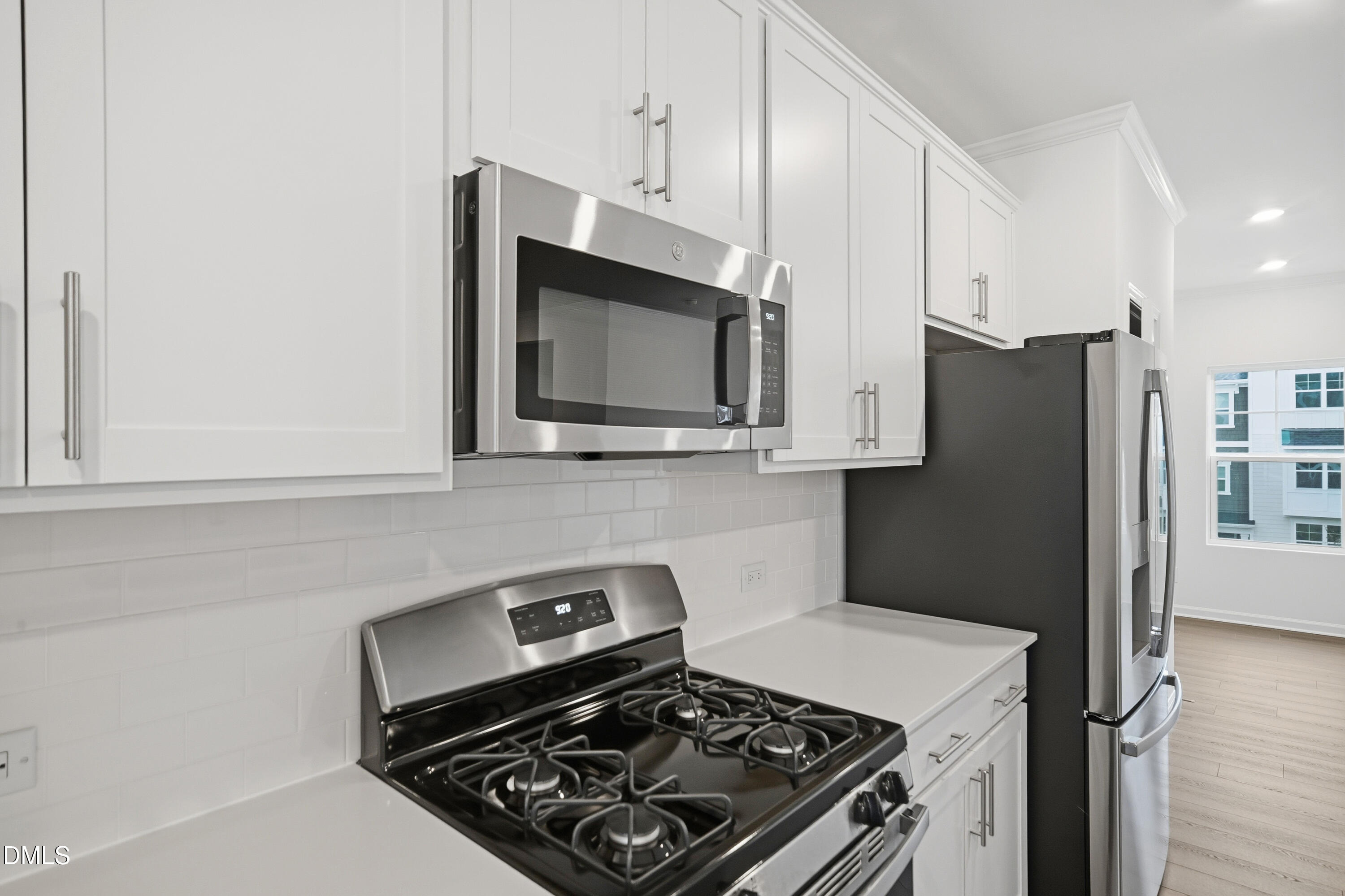 1445 Jay Road Knightdale, NC 27545 - Photo 10 of 58 a kitchen with stainless steel appliances a stove a microwave and a refrigerator