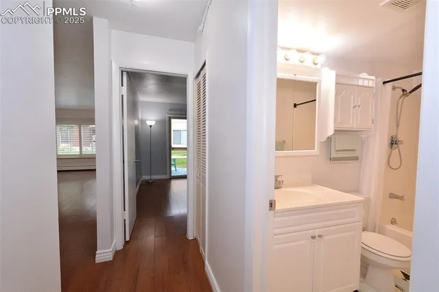 a view of an empty room with wooden floor