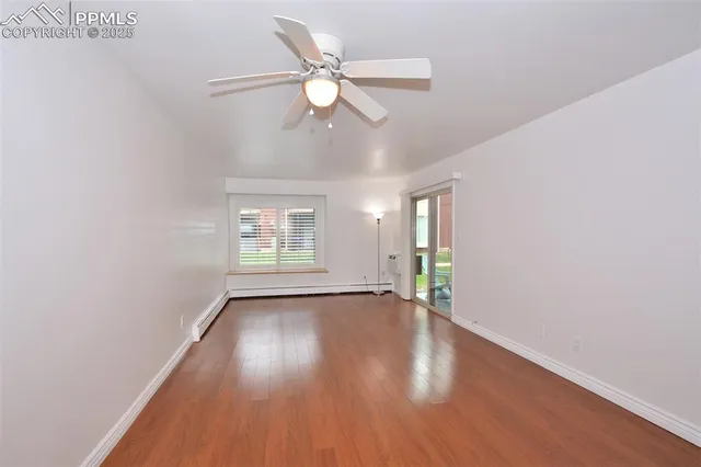 a view of an empty room and wooden floor