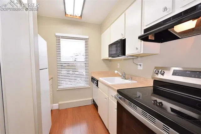 a kitchen with a sink a stove and refrigerator