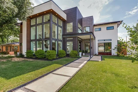 a front view of a brick house with a yard