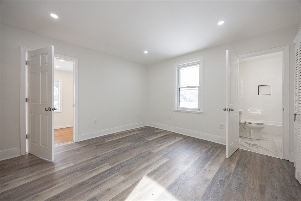 153 West Street Randolph, MA 02368 - Photo 11 of 33 an empty room with wooden floor and windows