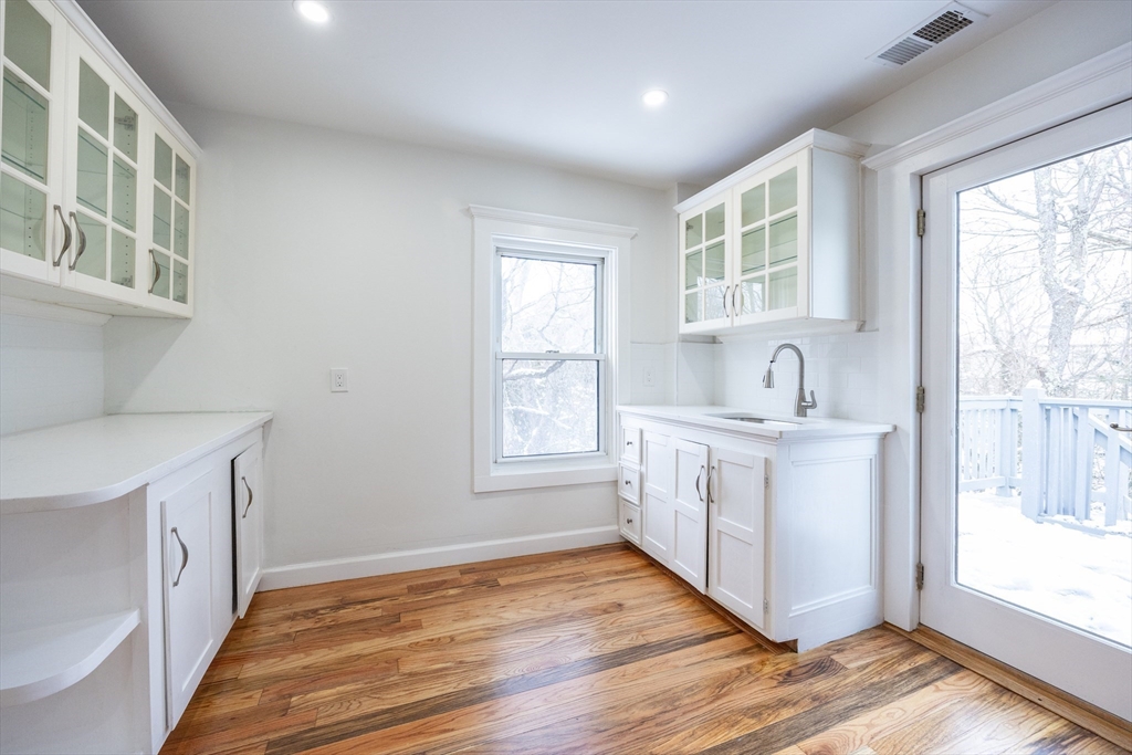 153 West Street Randolph, MA 02368 - Photo 20 of 33 a view of a kitchen with wooden floor and electronic appliances