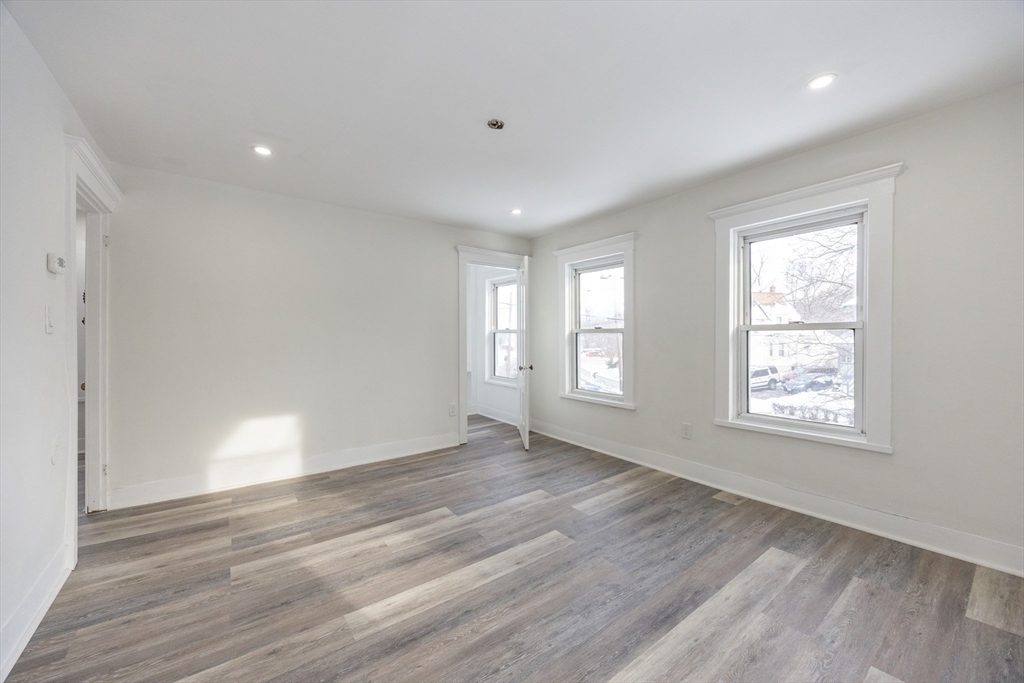 153 West Street Randolph, MA 02368 - Photo 21 of 33 a view of an empty room with wooden floor and window