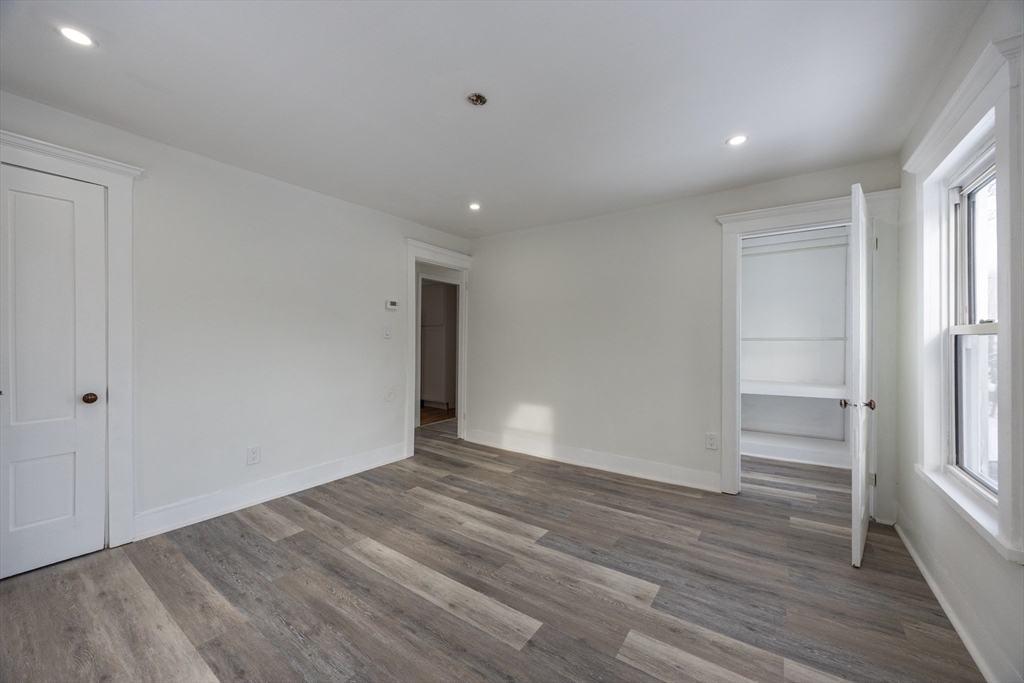 153 West Street Randolph, MA 02368 - Photo 24 of 33 wooden floor in an empty room with a window