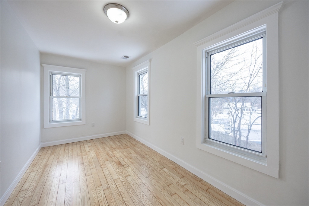 153 West Street Randolph, MA 02368 - Photo 26 of 33 a view of an empty room with wooden floor and a window