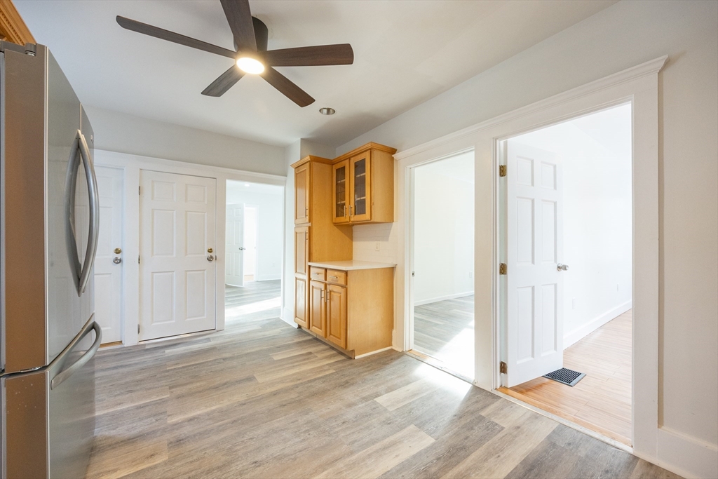 153 West Street Randolph, MA 02368 - Photo 5 of 33 a view of a livingroom with wooden floor and a ceiling fan