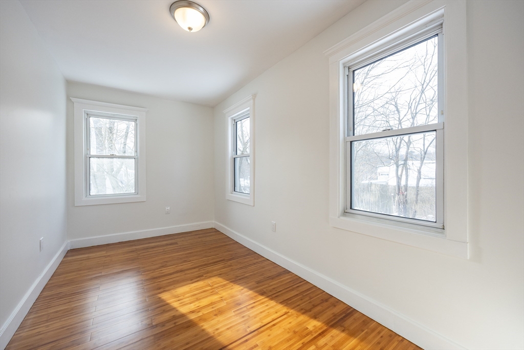 153 West Street Randolph, MA 02368 - Photo 8 of 33 a view of an empty room with wooden floor and a window