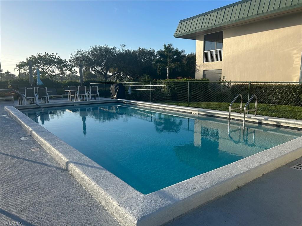 600 Valley Stream Drive, Unit E8 Naples, FL 34113 - Photo 21 of 21 a view of a swimming pool with a lake view