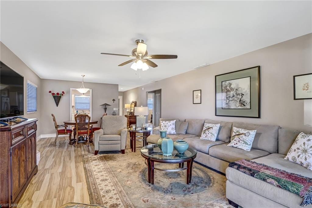 600 Valley Stream Drive, Unit E8 Naples, FL 34113 - Photo 7 of 21 a living room with furniture kitchen view and a flat screen tv