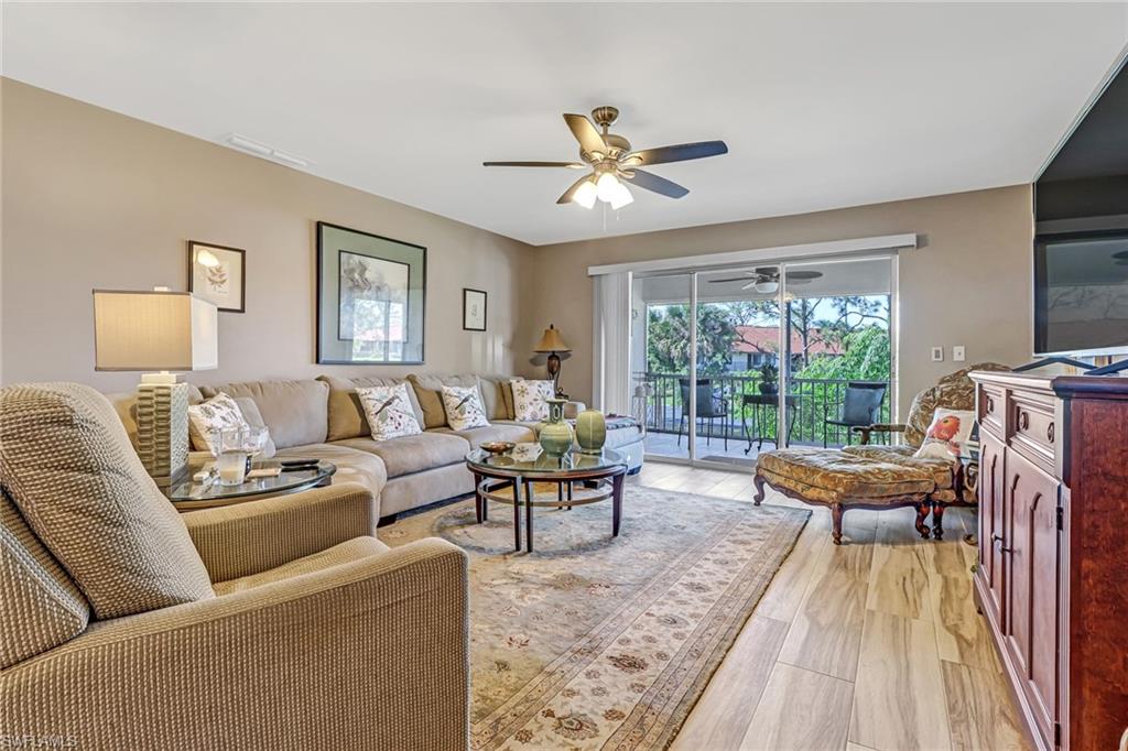 600 Valley Stream Drive, Unit E8 Naples, FL 34113 - Photo 9 of 21 a living room with furniture and a large window