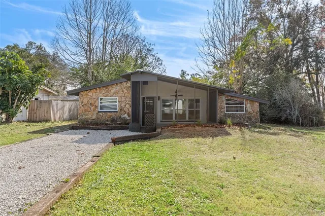 a view of a yard with a house and a tree