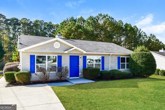 a front view of house with yard and green space