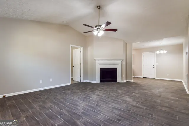 a view of an empty room with a fireplace