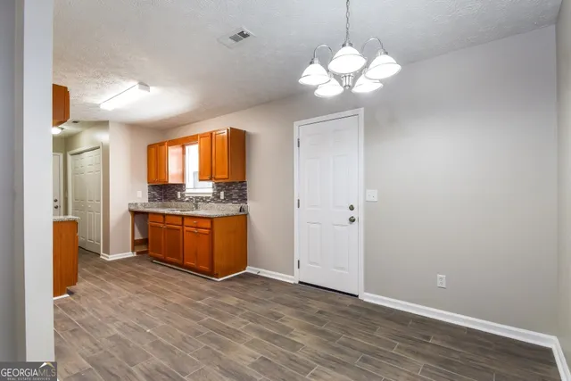 a kitchen with stainless steel appliances granite countertop a stove and a refrigerator