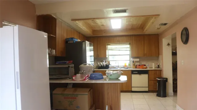 a kitchen with a sink appliances and cabinets